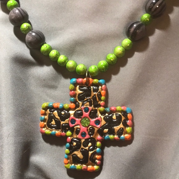 cross necklace with one colored bead